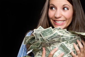 Beautiful smiling woman holding money